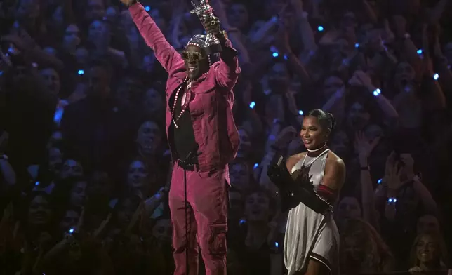 Flavor Flav, left, and Jordan Chiles present the award for best collaboration during the MTV Video Music Awards on Wednesday, Sept. 11, 2024, at UBS Arena in Elmont, N.Y. (Photo by Charles Sykes/Invision/AP)