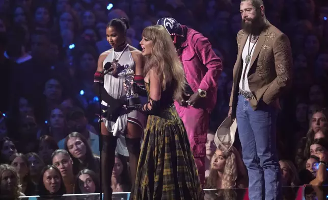 Taylor Swift, center, and Post Malone, far right, accept the award for best collaboration for "Fortnight" during the MTV Video Music Awards on Wednesday, Sept. 11, 2024, at UBS Arena in Elmont, N.Y. (Photo by Charles Sykes/Invision/AP)