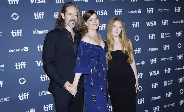 Darren Le Gallo, Amy Adams and Aviana Le Gallo, arrive on the red carpet for the premiere of 'Nightbitch' at Princess of Wales Theatre, during the Toronto International Film Festival in Toronto, Saturday, Sept. 7, 2024. (Cole Burston/The Canadian Press via AP)