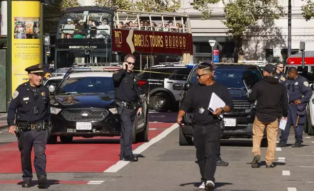 Police officers secure the area and investigate the scene of a shooting at Union Square in San Francisco, Saturday, Aug. 31, 2024. (Santiago Mejia/San Francisco Chronicle via AP)