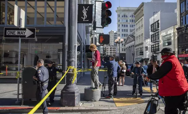 Police officers secure the area and investigate the scene of a shooting at Union Square in San Francisco, Saturday, Aug. 31, 2024. (Santiago Mejia/San Francisco Chronicle via AP)