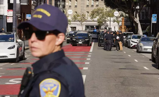 Police officers secure the area and investigate the scene of a shooting at Union Square in San Francisco, on Saturday, Aug. 31, 2024. (Santiago Mejia/San Francisco Chronicle via AP)