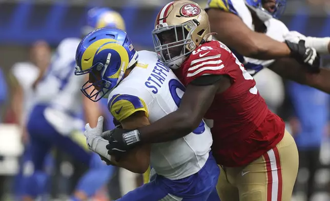 San Francisco 49ers defensive tackle Javon Hargrave, right, sacks Los Angeles Rams quarterback Matthew Stafford during the first half of an NFL football game, Sunday, Sept. 22, 2024, in Inglewood, Calif. (AP Photo/Ryan Sun)