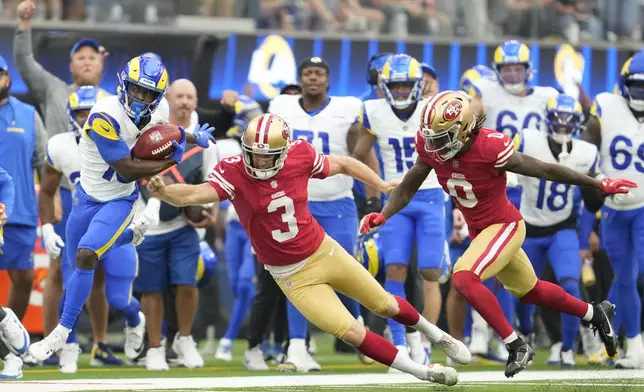 Los Angeles Rams' Xavier Smith, left, returns a punt past San Francisco 49ers punter Mitch Wishnowsky (3) and Renardo Green (0) during the second half of an NFL football game, Sunday, Sept. 22, 2024, in Inglewood, Calif. (AP Photo/Ashley Landis)