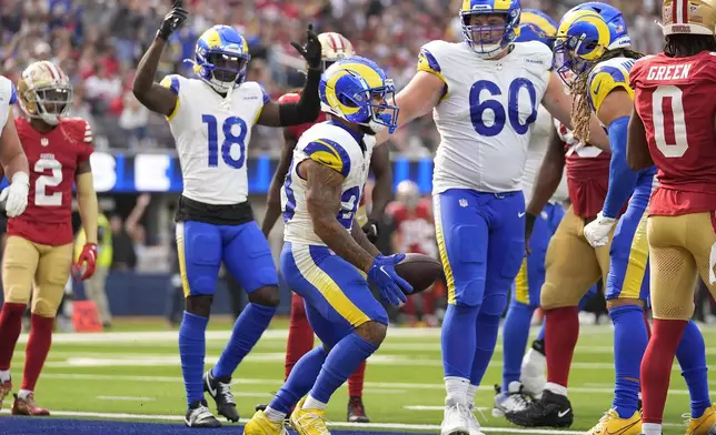 Los Angeles Rams running back Kyren Williams, middle, celebrates after scoring against the San Francisco 49ers during the second half of an NFL football game, Sunday, Sept. 22, 2024, in Inglewood, Calif. (AP Photo/Ashley Landis)