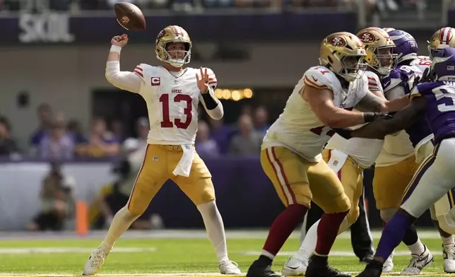 San Francisco 49ers quarterback Brock Purdy (13) fumbles the ball during the second half of an NFL football game against the Minnesota Vikings, Sunday, Sept. 15, 2024, in Minneapolis. (AP Photo/Abbie Parr)