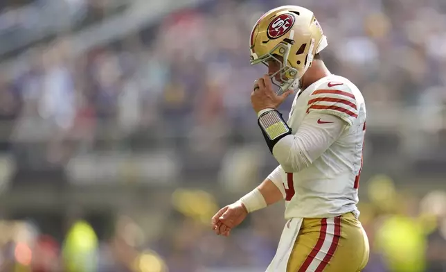 San Francisco 49ers quarterback Brock Purdy walks off the field after throwing an incomplete pass on fourth down during the first half of an NFL football game against the Minnesota Vikings, Sunday, Sept. 15, 2024, in Minneapolis. (AP Photo/Abbie Parr)