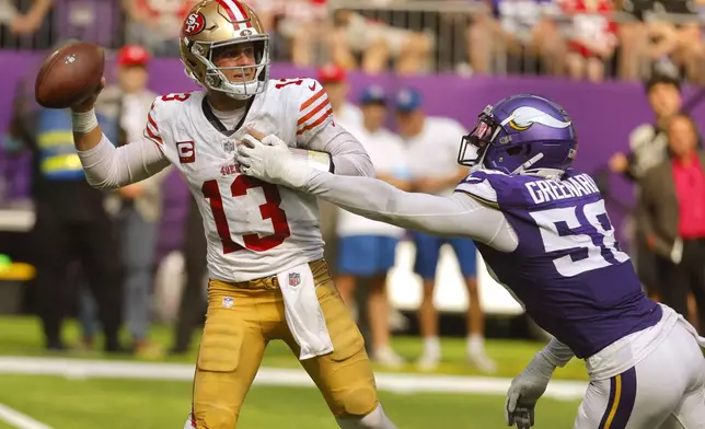 San Francisco 49ers quarterback Brock Purdy (13) throws a pass as he is pressured by Minnesota Vikings linebacker Jonathan Greenard (58) during the second half of an NFL football game, Sunday, Sept. 15, 2024, in Minneapolis. The Vikings won 23-17. (AP Photo/Bruce Kluckhohn)