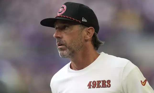 San Francisco 49ers head coach Kyle Shanahan walks on the field before an NFL football game against the Minnesota Vikings, Sunday, Sept. 15, 2024, in Minneapolis. (AP Photo/Abbie Parr)