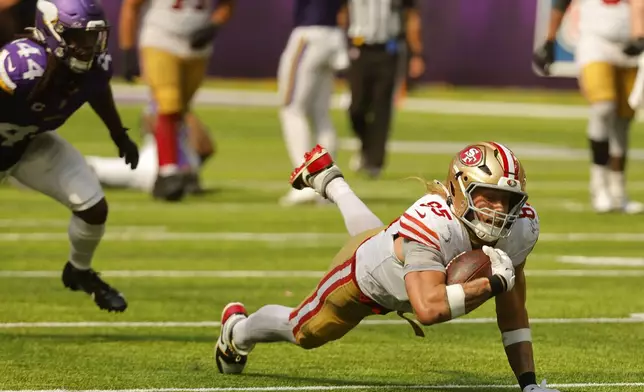 San Francisco 49ers tight end George Kittle (85) dives for extra yardage after catching a pass during the second half of an NFL football game against the Minnesota Vikings, Sunday, Sept. 15, 2024, in Minneapolis. (AP Photo/Bruce Kluckhohn)