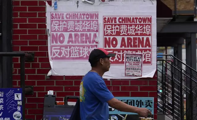 A man walks through the Chinatown neighborhood of Philadelphia, Wednesday, Sept. 18, 2024. (AP Photo/Matt Slocum)