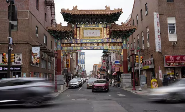 Evening traffic passes near the Chinatown neighborhood of Philadelphia, Wednesday, Sept. 18, 2024. (AP Photo/Matt Slocum)