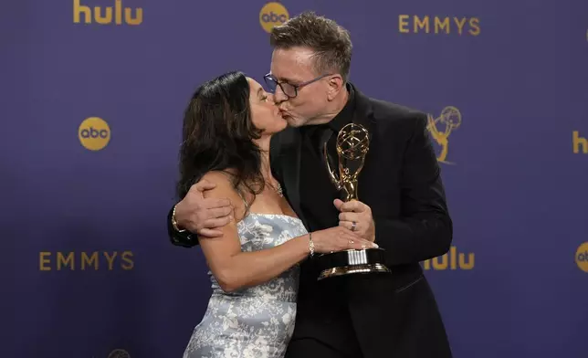 Ludmila Cliett, left, and Michael Cliett, winner of the award for outstanding special visual effects in a season or a movie for "Shogun", pose in the press room during the 76th Primetime Emmy Awards on Sunday, Sept. 15, 2024, at the Peacock Theater in Los Angeles. (AP Photo/Jae C. Hong)