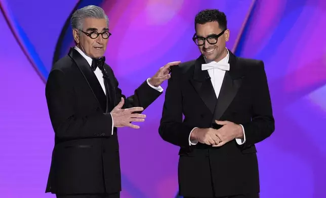 Hosts Eugene Levy, left, and Dan Levy speak during the 76th Primetime Emmy Awards on Sunday, Sept. 15, 2024, at the Peacock Theater in Los Angeles. (AP Photo/Chris Pizzello)