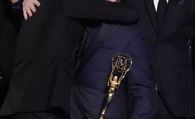 Justin Marks, left, and Hiroyuki Sanada embrace as they accept the award for outstanding drama series for "Shogun" during the 76th Primetime Emmy Awards on Sunday, Sept. 15, 2024, at the Peacock Theater in Los Angeles. (AP Photo/Chris Pizzello)