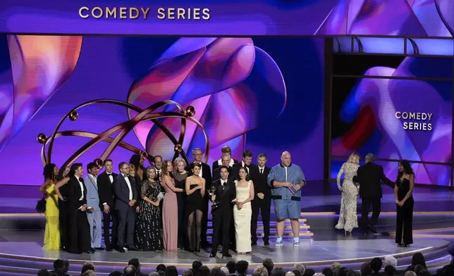 Jen Statsky, center from left, Paul W. Downs, and Lucia Aniello, and the team from "Hacks" accept the award for outstanding comedy series during the 76th Primetime Emmy Awards on Sunday, Sept. 15, 2024, at the Peacock Theater in Los Angeles. (AP Photo/Chris Pizzello)