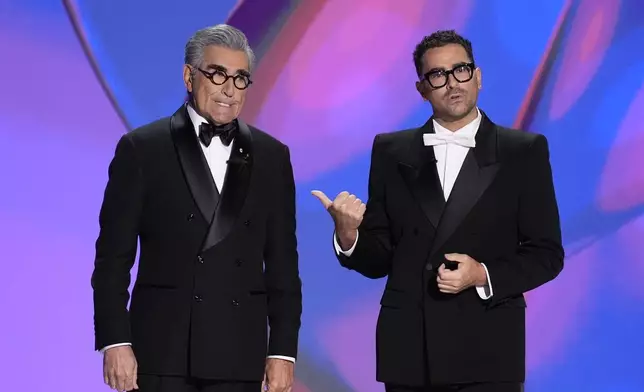 Hosts Eugene Levy and Dan Levy speak during the 76th Primetime Emmy Awards on Sunday, Sept. 15, 2024, at the Peacock Theater in Los Angeles. (AP Photo/Chris Pizzello)