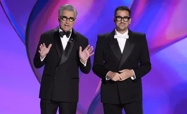 Hosts Eugene Levy, left, and Dan Levy speak during the 76th Primetime Emmy Awards on Sunday, Sept. 15, 2024, at the Peacock Theater in Los Angeles. (AP Photo/Chris Pizzello)