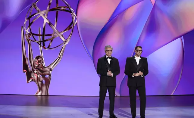 Hosts Eugene Levy, left, and Dan Levy speak during the 76th Primetime Emmy Awards on Sunday, Sept. 15, 2024, at the Peacock Theater in Los Angeles. (AP Photo/Chris Pizzello)