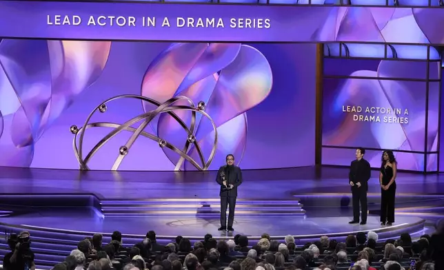 Hiroyuki Sanada accepts the award for outstanding lead actor in a drama series for "Shogun" during the 76th Primetime Emmy Awards on Sunday, Sept. 15, 2024, at the Peacock Theater in Los Angeles. Steven Yeun looks on from right.(AP Photo/Chris Pizzello)