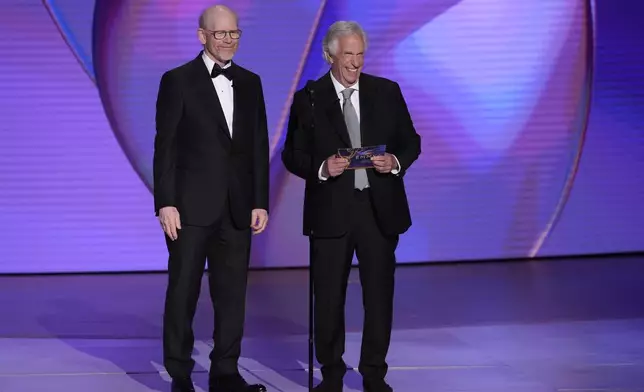 Ron Howard, left, and Henry Winkler present the award for outstanding directing for a comedy series during the 76th Primetime Emmy Awards on Sunday, Sept. 15, 2024, at the Peacock Theater in Los Angeles. (AP Photo/Chris Pizzello)