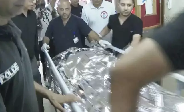 ADDS WITNESSES TO THE SHOOTING - This image taken from an Associated Press video shows Aysenur Ezgi Eygi's body being transported through the Rafidia Surgical Hospital, where she was taken after after witnesses say she was fatally shot by Israeli soldiers, Sept. 6, 2024, in the West Bank city of Nablus. (AP Photo/Aref Tufaha)