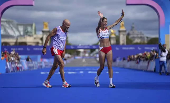 ADDITION ELENA CONGOST WAS DISQUALIFIED FOR LETTING GO OF THE ROPE TO HELP HER GUIDE - Spain's Elena Congost, right, celebrates as she arrives in third position in the women's marathon T12 at the 2024 Paralympics, Sunday, Sept. 8, 2024, in Paris, France. (AP Photo/Thibault Camus)