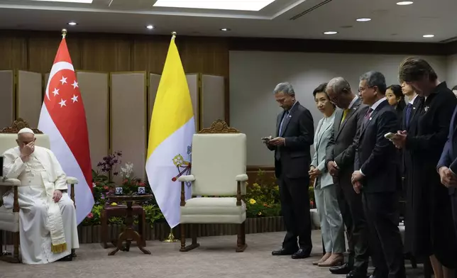 Pope Francis, left, and from right, Singapore's Non-Resident Ambassador to the Holy See Ang Janet Guat Har, Culture Minister Edwin Tong, Minister for Social and Family Development Masagos Zulkifli, Minister for Sustainability and the Environment Grace Fu Hai Yien, and Foreign Minister Vivian Balakrishnan wait for the Prime Minister of Singapore, Lawrence Wong at the Parliament House in Singapore, Thursday, Sept. 12, 2024. Pope Francis flew to Singapore on Wednesday for the final leg of his trip through Asia, arriving in one of the world’s richest countries from one of its poorest after a record-setting final Mass in East Timor. (AP Photo/Gregorio Borgia, pool)