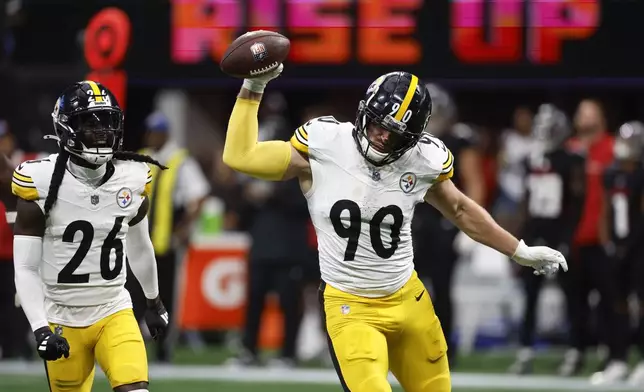 Pittsburgh Steelers linebacker T.J. Watt (90) celebrates after recovering a fumble during the second half of an NFL football game against the Atlanta Falcons on Sunday, Sept. 8, 2024, in Atlanta. (AP Photo/Butch Dill)