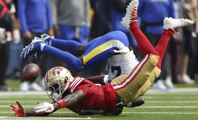 San Francisco 49ers wide receiver Brandon Aiyuk, bottom, cannot catch a pass while defended by Los Angeles Rams cornerback Tre'Davious White during the first half of an NFL football game, Sunday, Sept. 22, 2024, in Inglewood, Calif. (AP Photo/Ryan Sun)