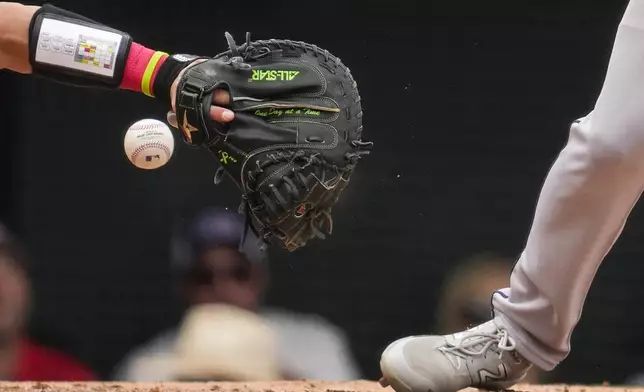 Los Angeles Angels catcher Logan O'Hoppe, left, misses a throw to Houston Astros' Jake Meyers, right, during the fourth inning of a baseball game in Anaheim, Calif., Sunday, Sept. 15, 2024. Houston Astros' Jeremy Peña scored off of the passed ball. (AP Photo/Ashley Landis)