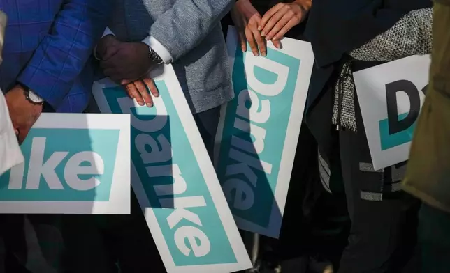 Supporters of the OVP, Austrian People's Party, hold "Thank You" banners at the party headquarters in Vienna, Austria, Sunday, Sept. 29, 2024, after seeing the first electoral projections in the country's national election. (AP Photo/Andreea Alexandru)