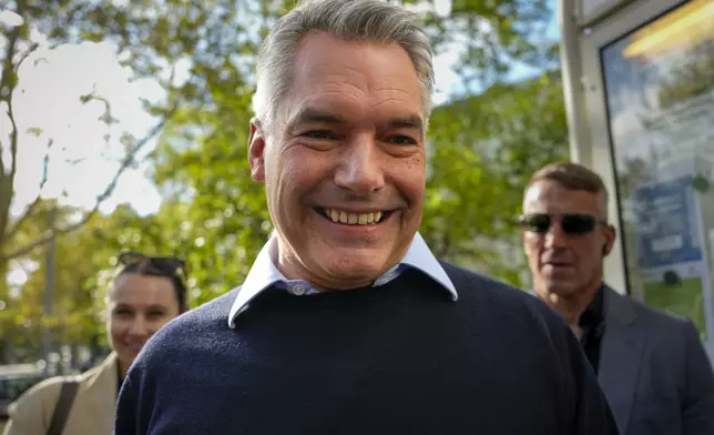 Austrian Chancellor Karl Nehammer smiles upon arriving at a polling station in Vienna, Austria, Sunday, Sept. 29, 2024, to cast his vote in the country's national election. (AP Photo/Andreea Alexandru)