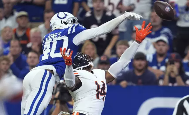 Indianapolis Colts cornerback Jaylon Jones (40) tips the ball away from Chicago Bears tight end Gerald Everett (14) during the first half of an NFL football game Sunday, Sept. 22, 2024, in Indianapolis. (AP Photo/Michael Conroy)