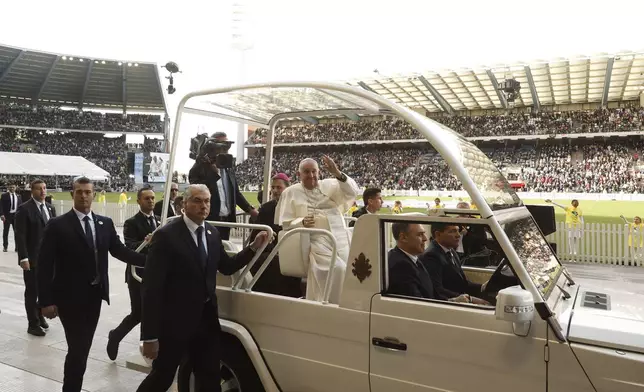 Pope Francis waves as he arrives to lead the holy mass , at the King Baudouin stadium in Brussels, Belgium, Sunday, Sept. 29, 2024. (AP Photo/Omar Havana)