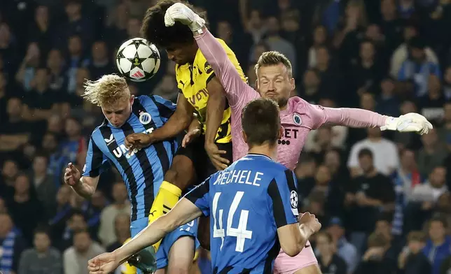 Brugge's Joaquin Seys, Dortmund's Karim Adeyemi and Brugge's goalkeeper Simon Mignolet, from left, challenge for the ball during the Champions League opening phase soccer match between Club Brugge and Borussia Dortmund at Jan Breydelstadion in Bruges, Belgium, Wednesday, Sept. 18, 2024. (AP Photo/Omar Havana)