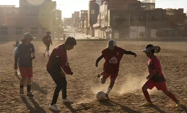 Children play soccer near the Municipal Villa Ingenio stadium in El Alto, Bolivia, Thursday, Aug. 29, 2024. (AP Photo/Juan Karita)