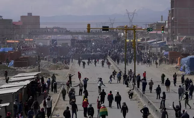 Supporters of former President Evo Morales, below, face off with supporters current President Luis Arce in El Alto, Bolivia, Sunday, Sept. 22, 2024. (AP Photo/Juan Karita)