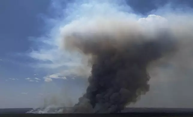 Smoke rises from fire in the environmentally protected area of Brasilia National Park during the dry season in Brasilia, Brazil, Monday, Sept. 16, 2024. The head of the agency that manages protected areas, Mauro Pires, told the local press that the fire is man-made and appears to have started near the edge of the presidency's official countryside residence. (AP Photo/Eraldo Peres)