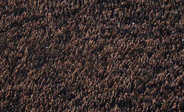 Corinthians fans cheer in the stands of the Neo Quimica arena during a Brazilian soccer league match between Corinthians and Flamengo in Sao Paulo, Brazil, Sunday, Sept. 1, 2024. The arena is set to host an NFL football game between the Green Bay Packers and the Philadelphia Eagles on Sept. 6. (AP Photo/Andre Penner)