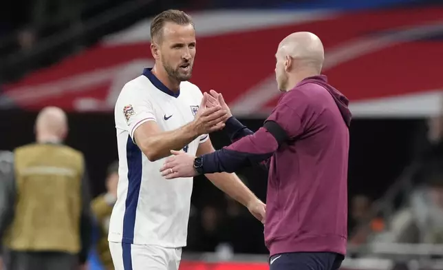 England's Harry Kane, left, is congratulated by England interim manager Lee Carsley after scoring his side's second goal during the Group F UEFA Nations League soccer match between England and Finland at Wembley Stadium in London, Tuesday, Sept. 10, 2024. (AP Photo/Frank Augstein)