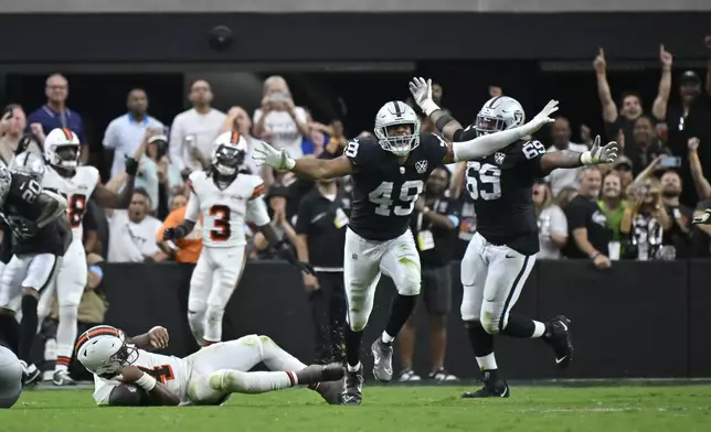 Las Vegas Raiders defensive end Charles Snowden, center, celebrates after sacking Cleveland Browns quarterback Deshaun Watson, left, during the second half of an NFL football game Sunday, Sept. 29, 2024, in Las Vegas. (AP Photo/David Becker)