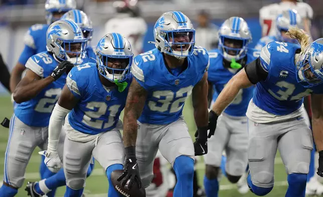 Detroit Lions safety Brian Branch (32) reacts after intercepting a pass intended for Tampa Bay Buccaneers wide receiver Mike Evans during the first half of an NFL football game, Sunday, Sept. 15, 2024, in Detroit. (AP Photo/Paul Sancya)