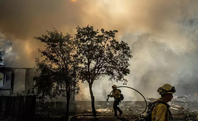 Firefighters battle the Boyles fire in Clearlake, Calif., on Sunday, Sept. 8, 2024. (AP Photo/Noah Berger)