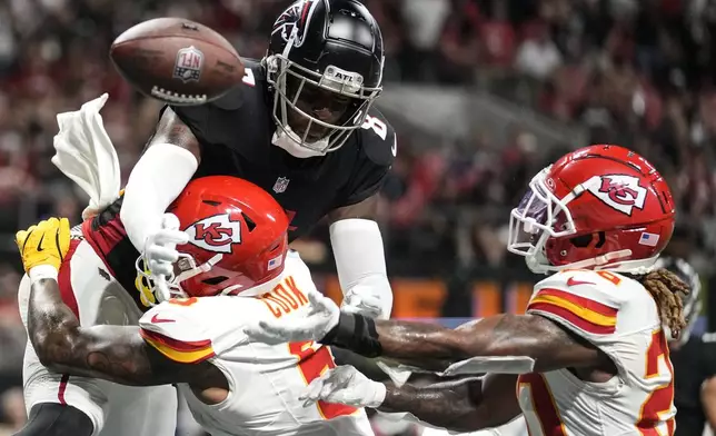 Atlanta Falcons tight end Kyle Pitts (8) misses the catch against Kansas City Chiefs safety Bryan Cook (6) during the second half of an NFL football game, Sunday, Sept. 22, 2024, in Atlanta. (AP Photo/Brynn Anderson)