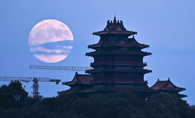 A supermoon rises over a pagoda during the Mid Autumn Festival in Nanjing, in east China's Jiangsu province, Tuesday, Sept. 17, 2024. (Chinatopix Via AP)