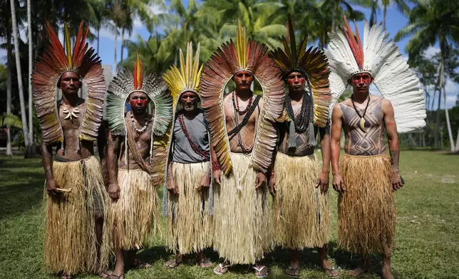 Apolima-Arara Indigenous men pose for a picture during the annual celebration recognizing the Ashaninka territory in the Apiwtxa village, Acre state, Brazil, Monday, June 24, 2024. (AP Photo/Jorge Saenz)