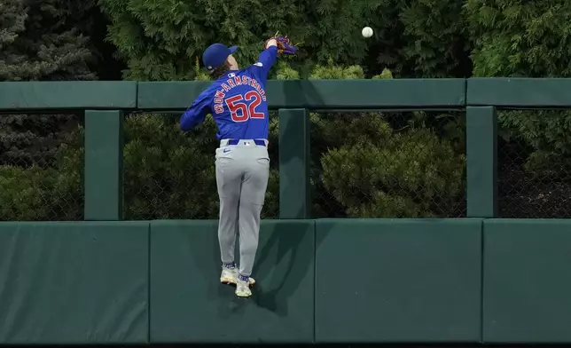 Chicago Cubs center fielder Pete Crow-Armstrong cannot reach a home run by Philadelphia Phillies' Kody Clemens during the fourth inning of a baseball game, Wednesday, Sept. 25, 2024, in Philadelphia. (AP Photo/Matt Slocum)
