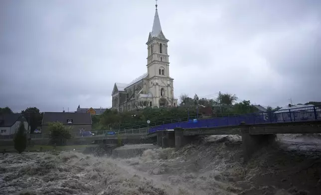 The Bela River flows past a church during floods in Mikulovice, Czech Republic, Saturday, Sept. 14, 2024. (AP Photo/Petr David Josek)