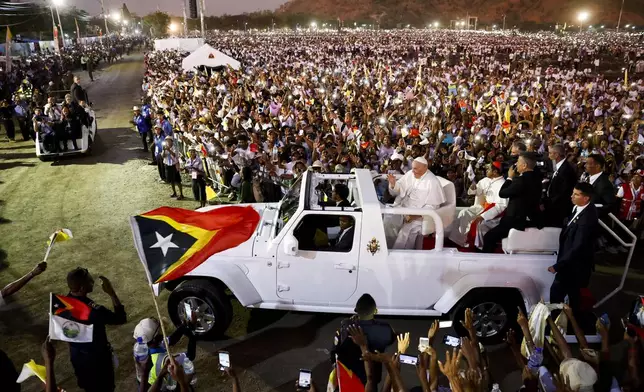 Pope Francis waves out of the car on the day of the Holy Mass at the Esplanade of Taci Tolu during his apostolic trip to Asia, in Dili, East Timor, Tuesday, Sept. 10, 2024. (Willy Kurniawan/Pool Photo via AP)